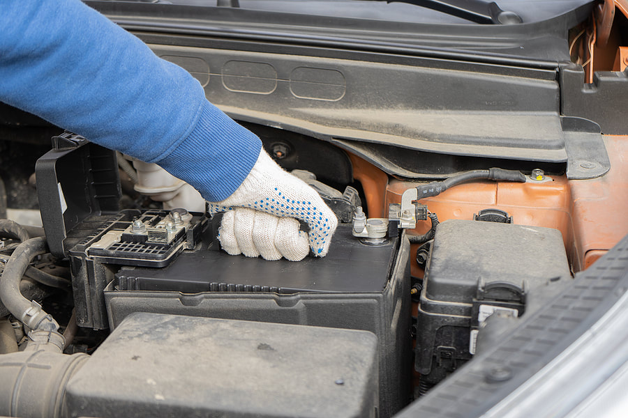 worker replacing damage engine battery