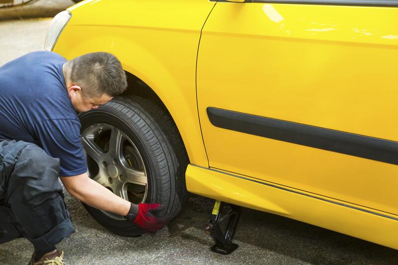 worker repairing flat tire